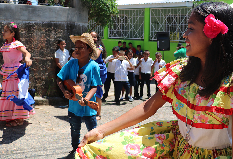 A photo of students preforming a traditional dance