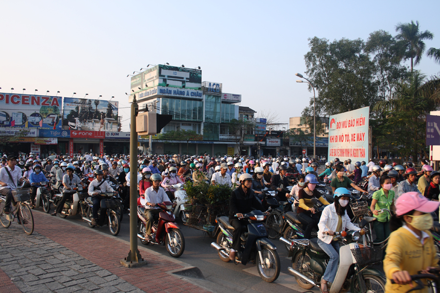 Photo of a street in Vietnam filled with motorcycle traffic.