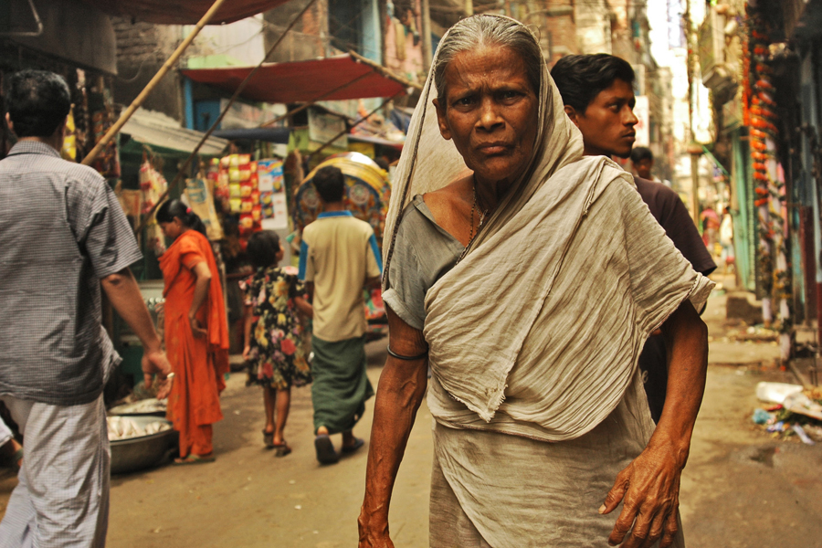 Photo of a woman walking through the streets of India.