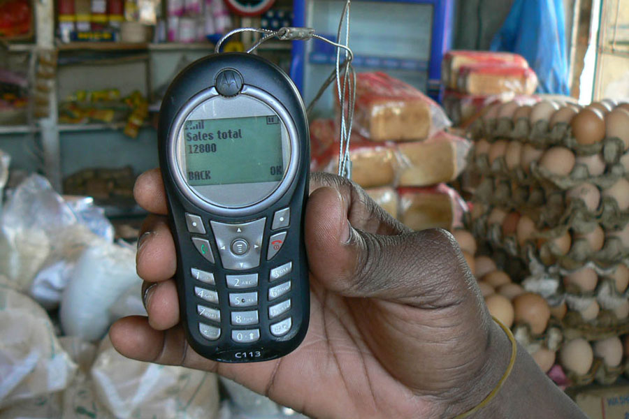 Photo of a mobile phone displaying a slaes recreipt.