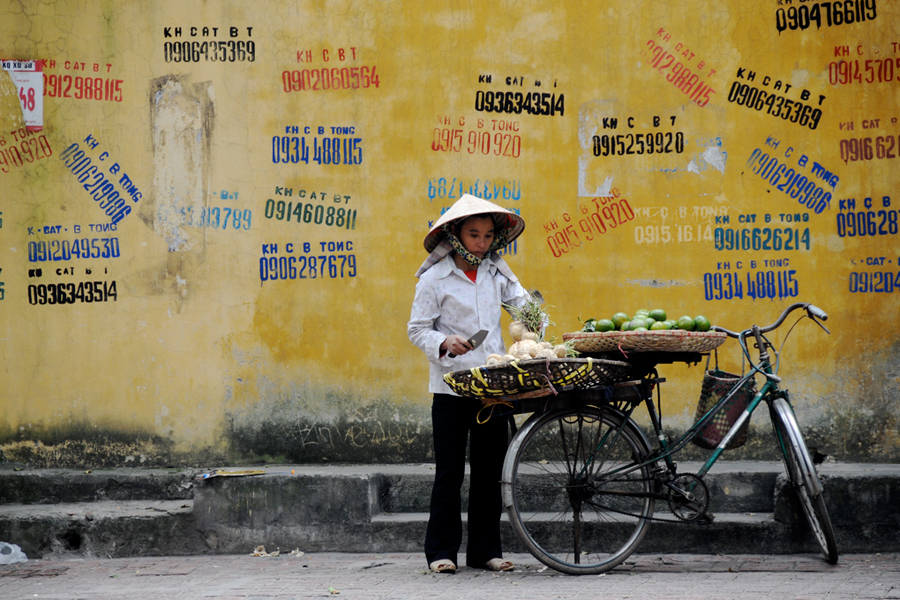 Photo of a woman street vendor in Hanoi, Vietnam.