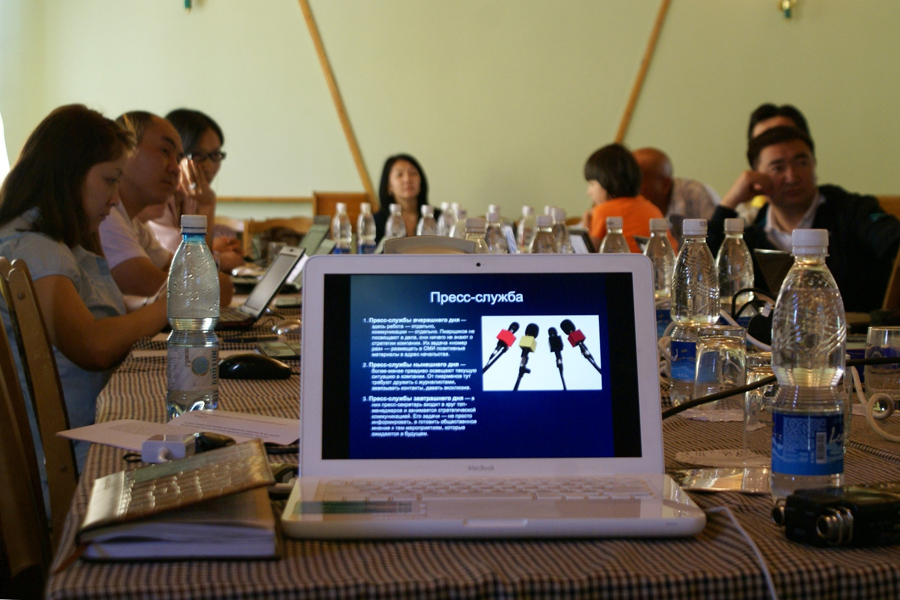 Photo of a laptop on a desk with training materials on the screen.